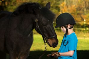 Wyatt, a client pictured with G-Whiz the horse